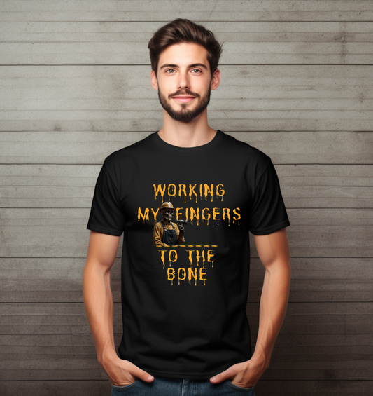 Man wearing a black t-shirt with yellow text and graphic against a wooden background